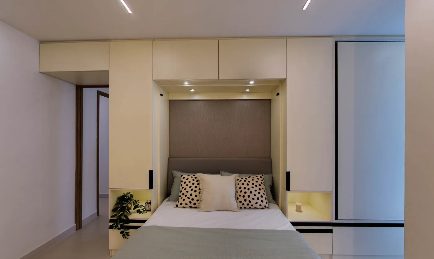 The master bedroom, a bed set into a smart wall unit with lit niches