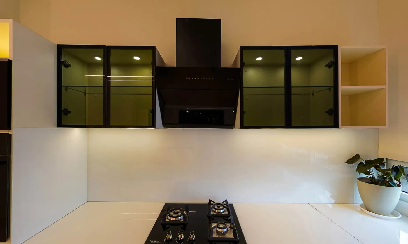 The penthouse kitchen with glass-front upper cabinets and a hob